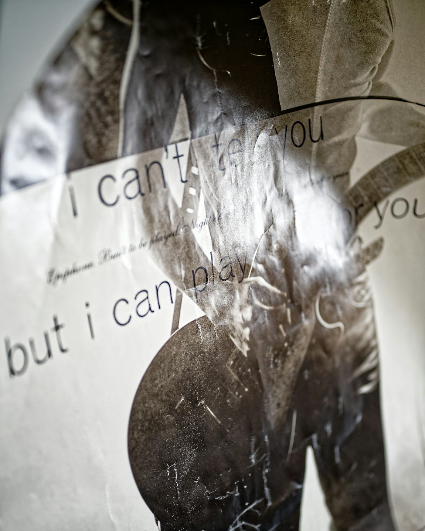 High-contrast black-and-white typographic poster printed on textured paper